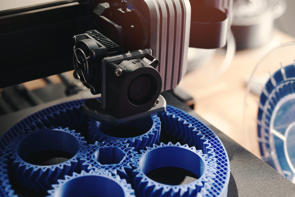 A 3D printer in action, creating an object using plastic additives