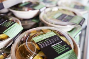 Plastic food packaging keeps salads fresh in a grocery store.